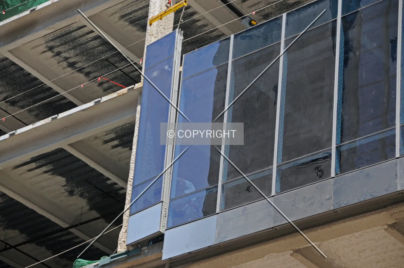 Workers installing a window on the first office floor