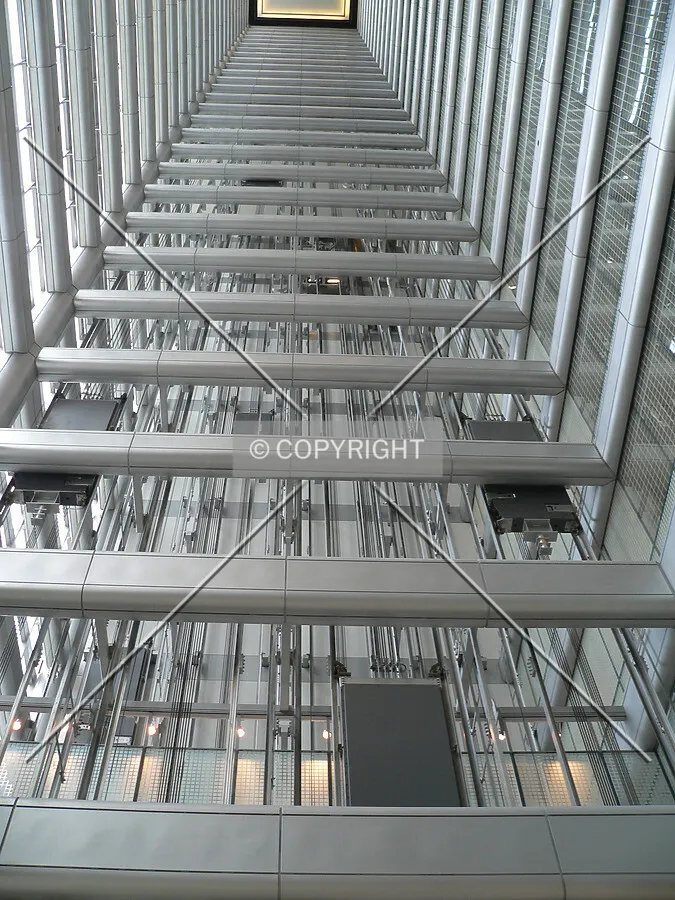 Looking up through the eastern atrium from the main level with the elevator weights and cables visible