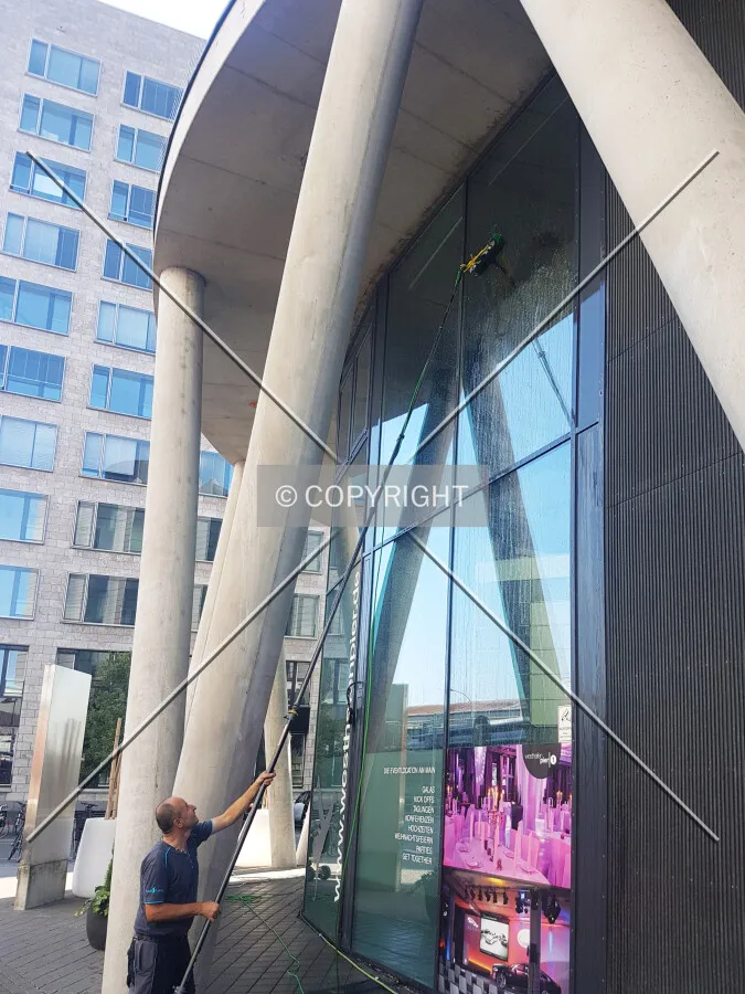 A man is cleaning the facade