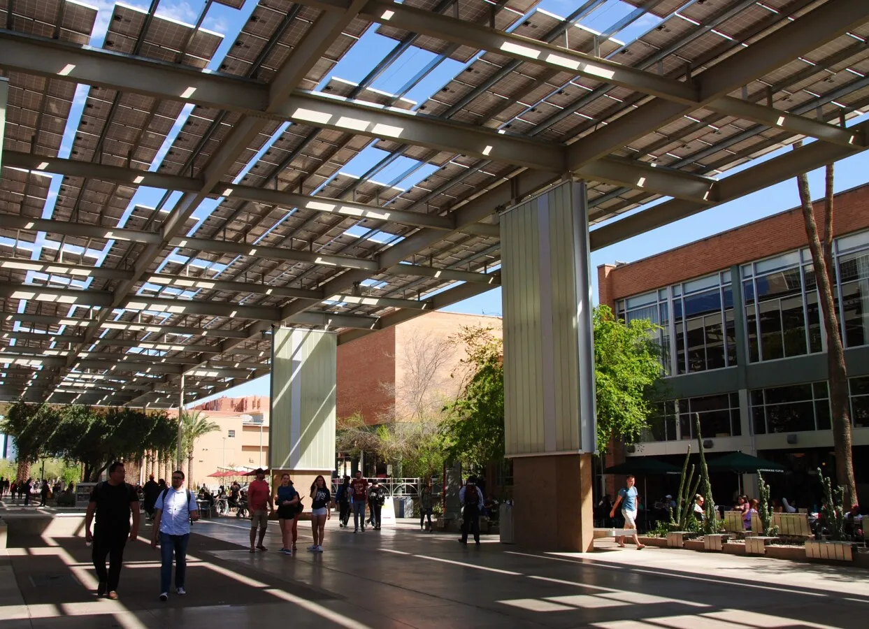 Pedestrian walkway under a canopy of solar panels
