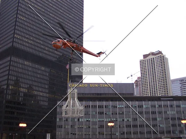 Helicopter rising with the top of the building