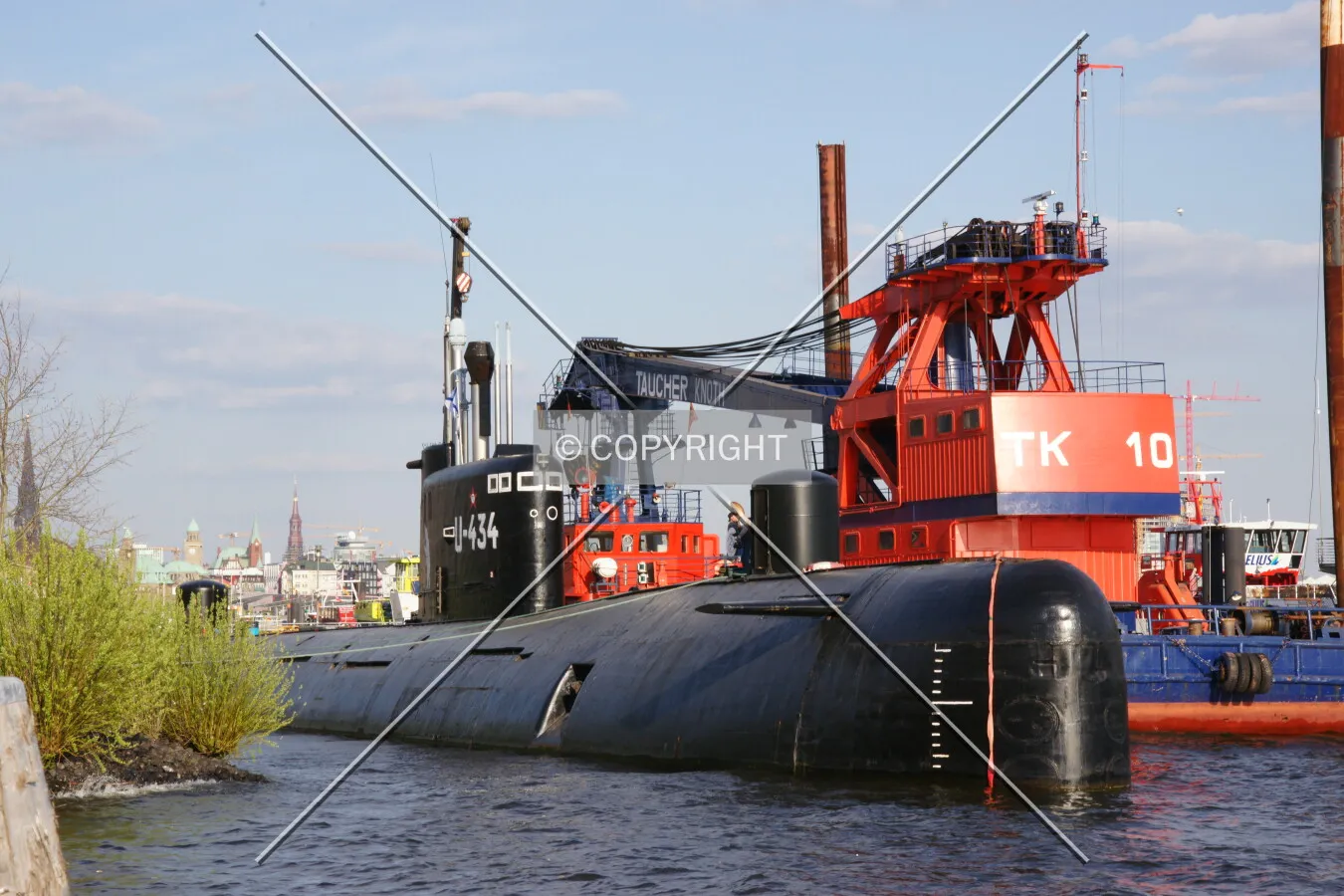 A black submarine lying in the water