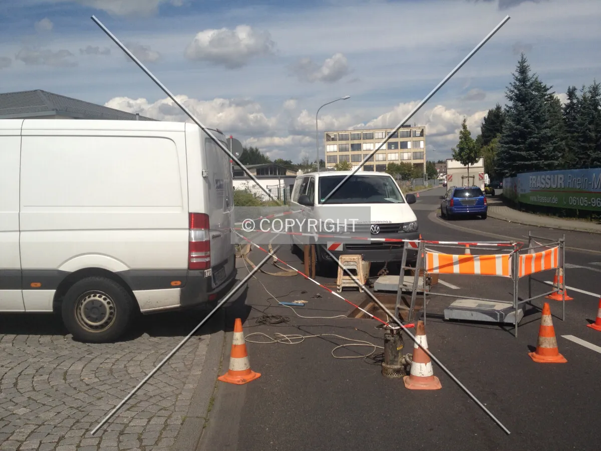 A construction site; a telecom company is repairing network connections under the street