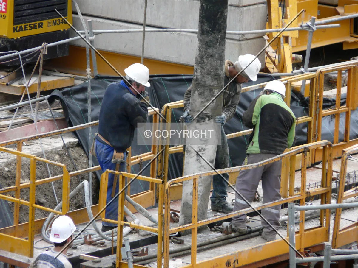 Workers pouring a wall of the underground floor
