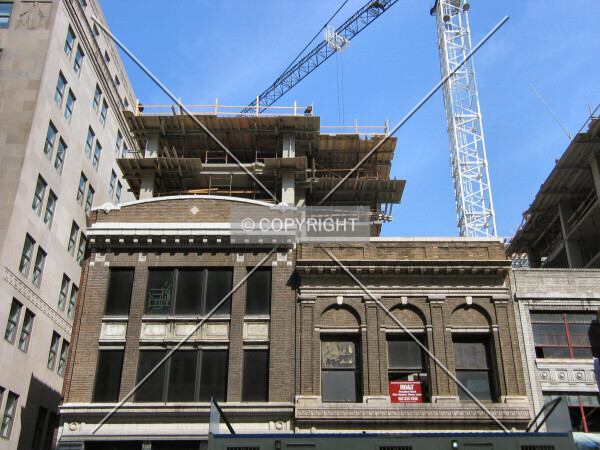 Rising above existing buildings, from E Street NW