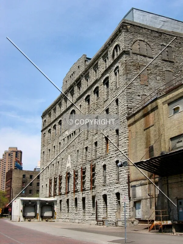 Bowed facade of the original mill building, from Main Street SE