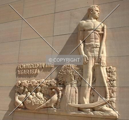 Farmer relief, left of 6th Street entrance to Old Banking Hall