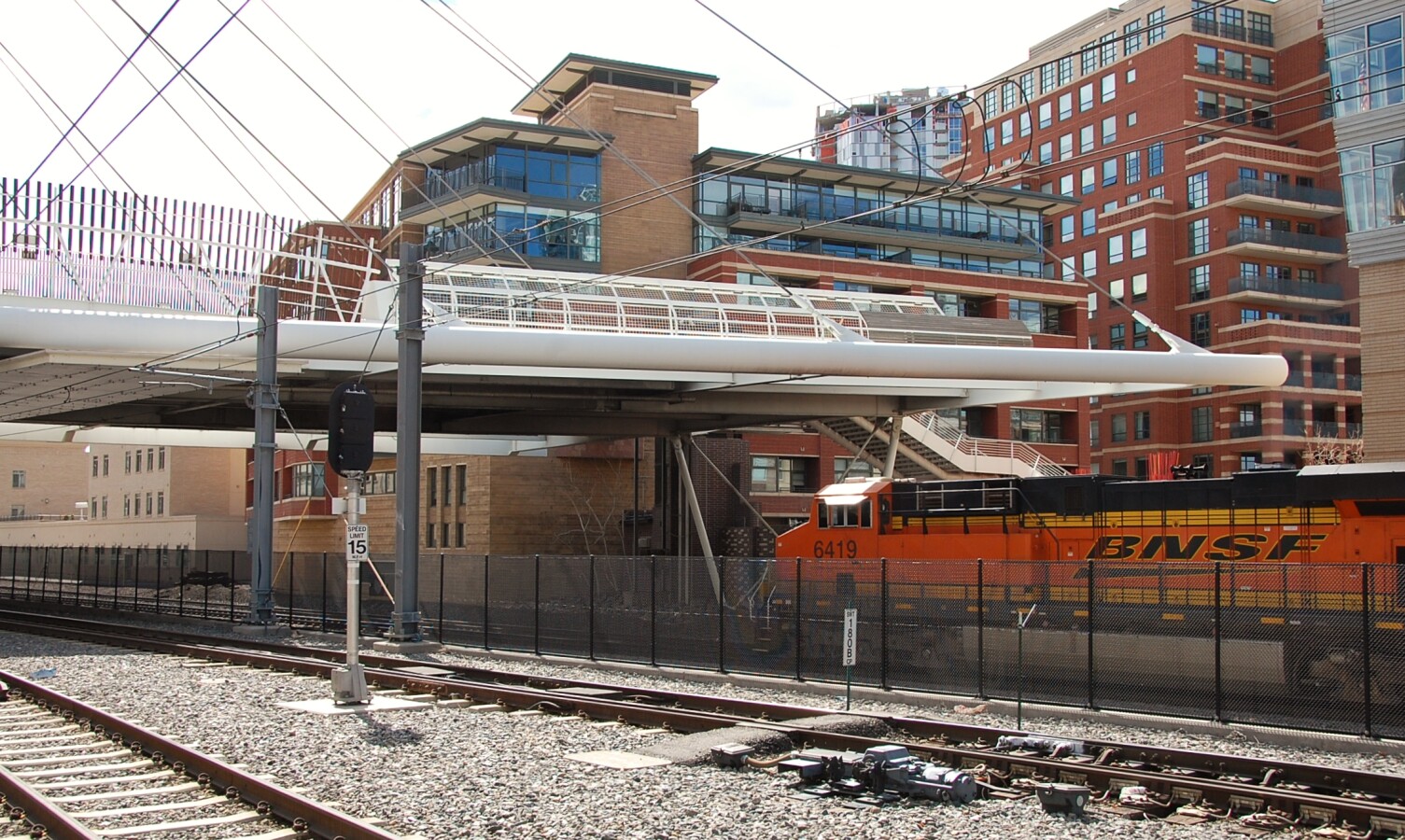 A BNSF train about to pass under the bridge