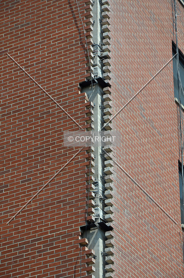 Bricks removed from the southwest corner during a facade renovation, exposing the reinforced concrete frame. August 27, 2013.