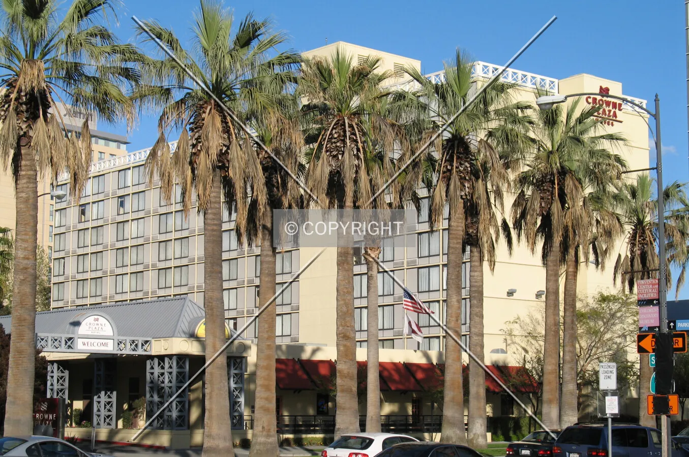 Northwest corner obscured by palm trees along South Almaden Boulevard