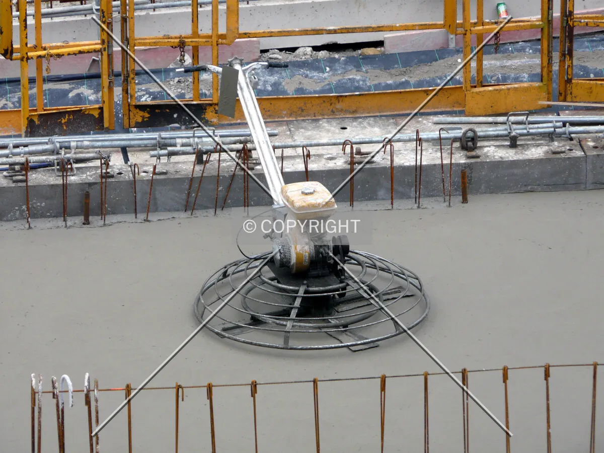 Mechanical trowel on the recently poured slab of second floor