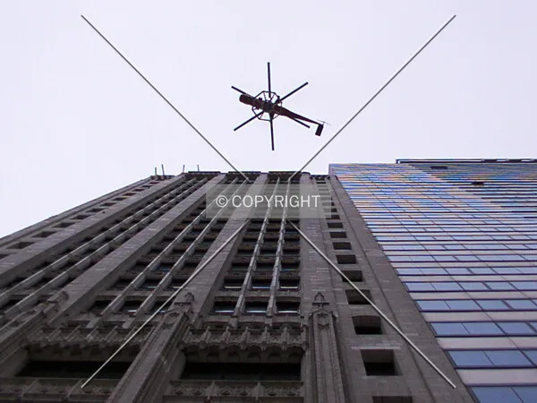 Under the helicopter, carrying the top piece