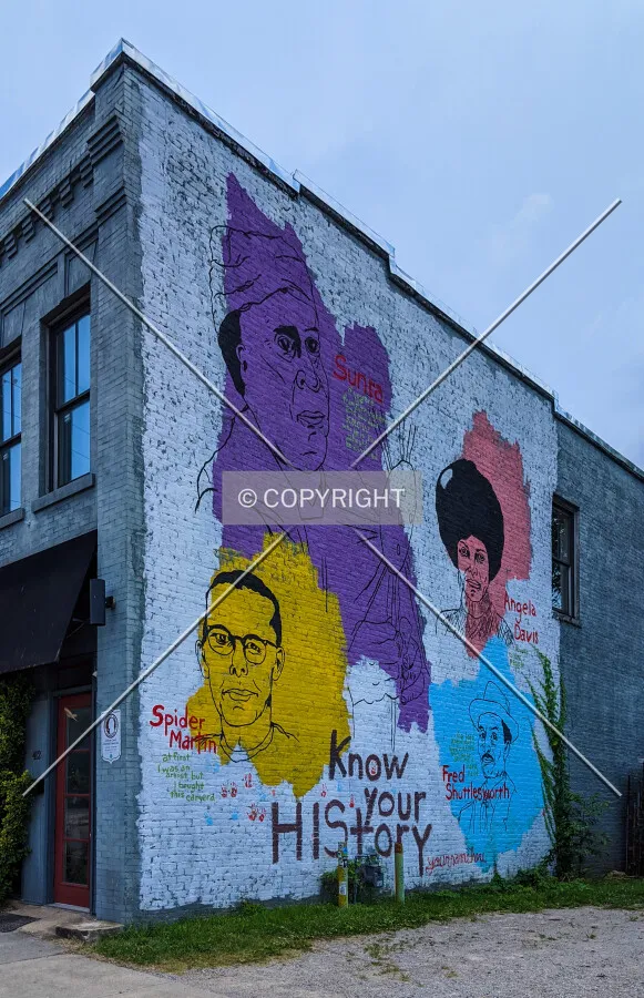 "Know Your History" mural on the northern facade featuring Fred Shuttlesworth, Sun Ra, Angela Davis, and Spider Martin