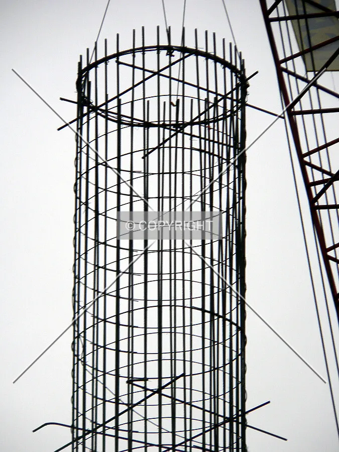 Rebar cage being lowered into a caisson hole