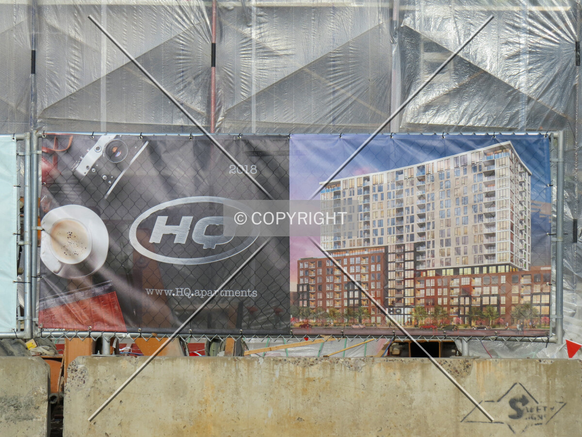 Building logo and rendering on construction fence