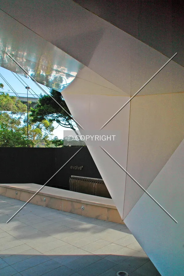 Beneath the sculptured awning at the entrance