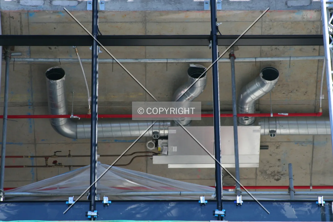 Looking up at the air-conditioning pipes