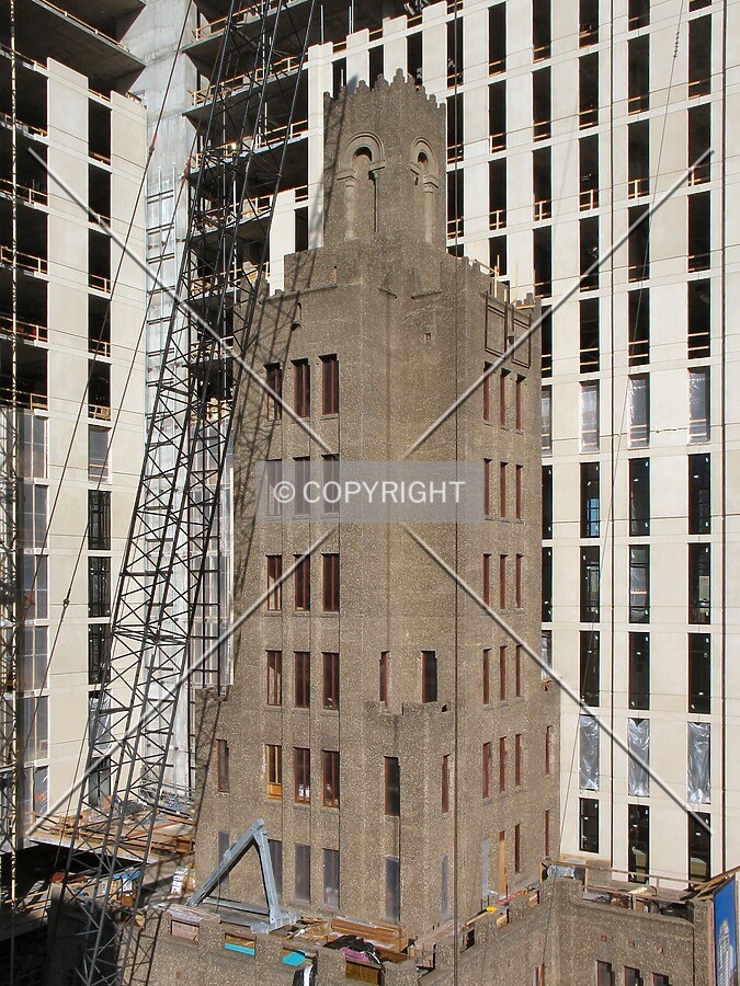 New construction enveloping the existing Ivy Tower