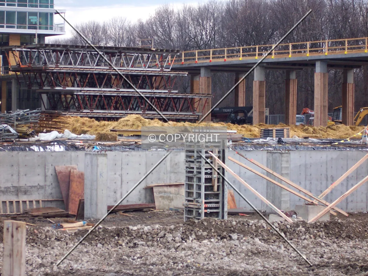 Looking southwest into the site. The columns and foundation walls in the foreground are rising out of the Maple Tower's lower level