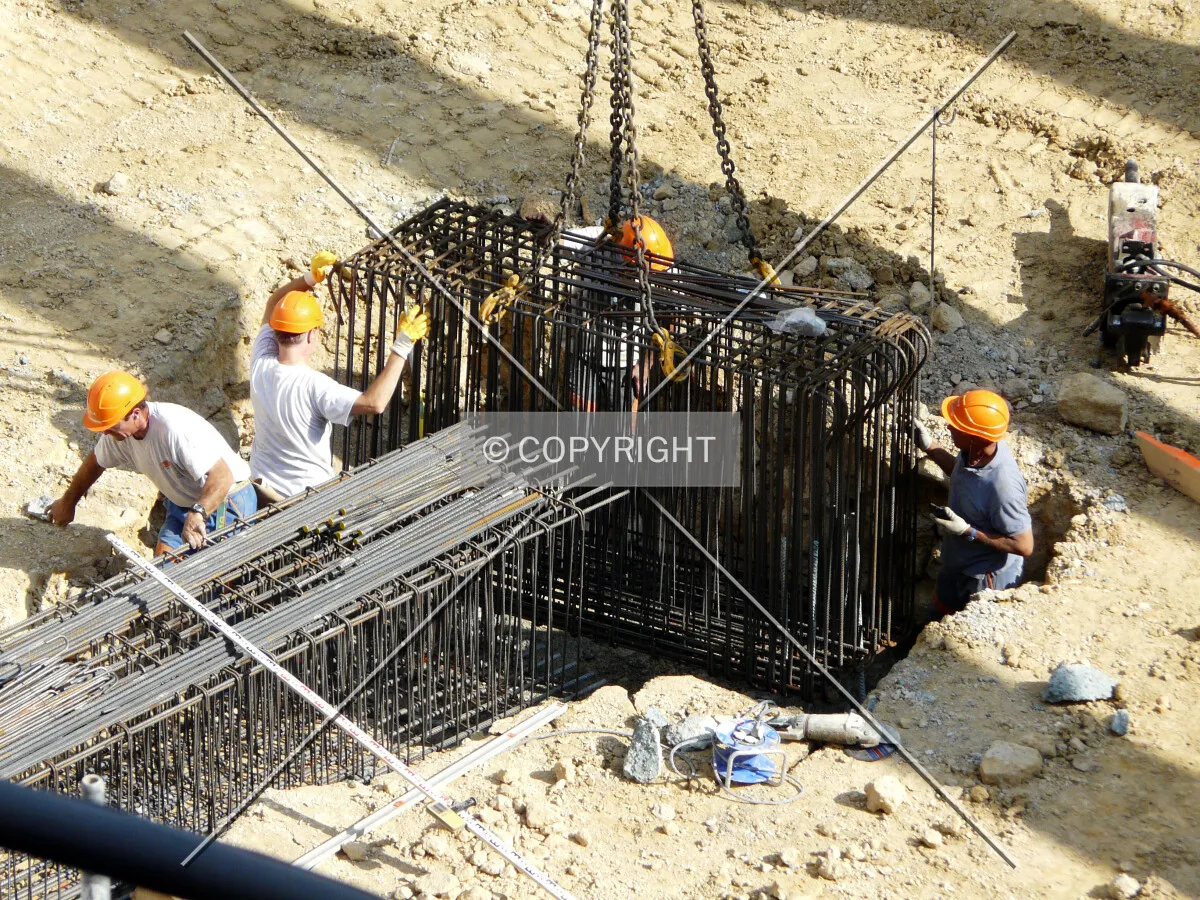 Workers putting in place rebars for the tower crane's concrete platform