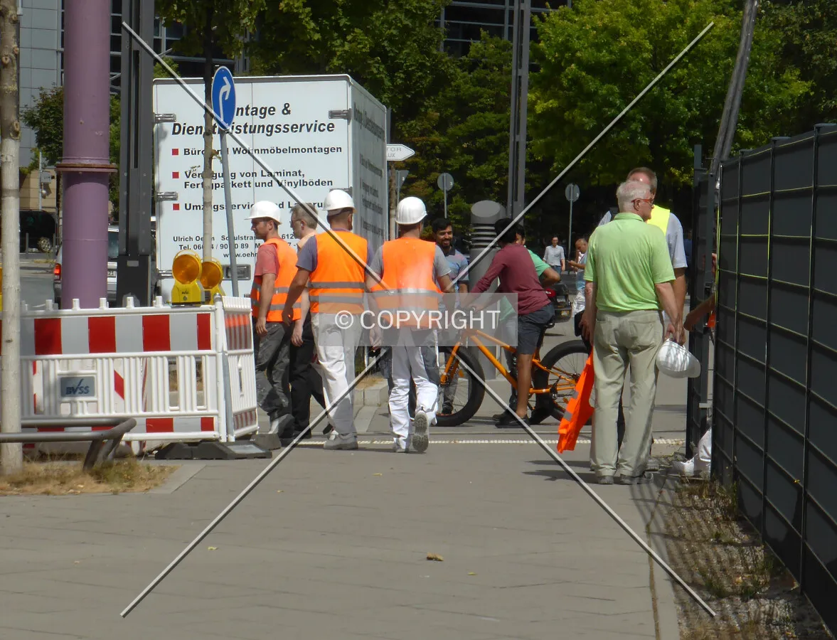 Construction workers walking on the street in Frankfurt, Germany