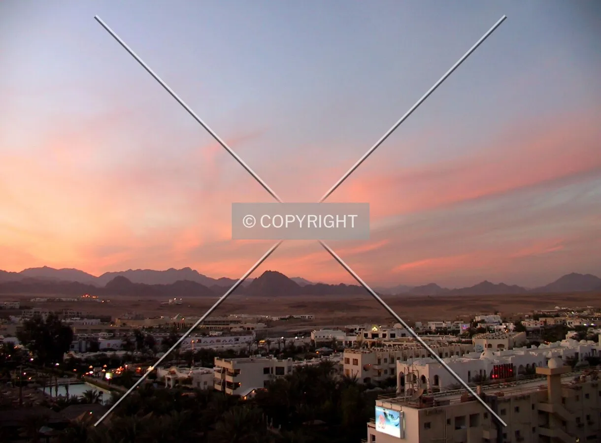 Sunset over the town and the desert
