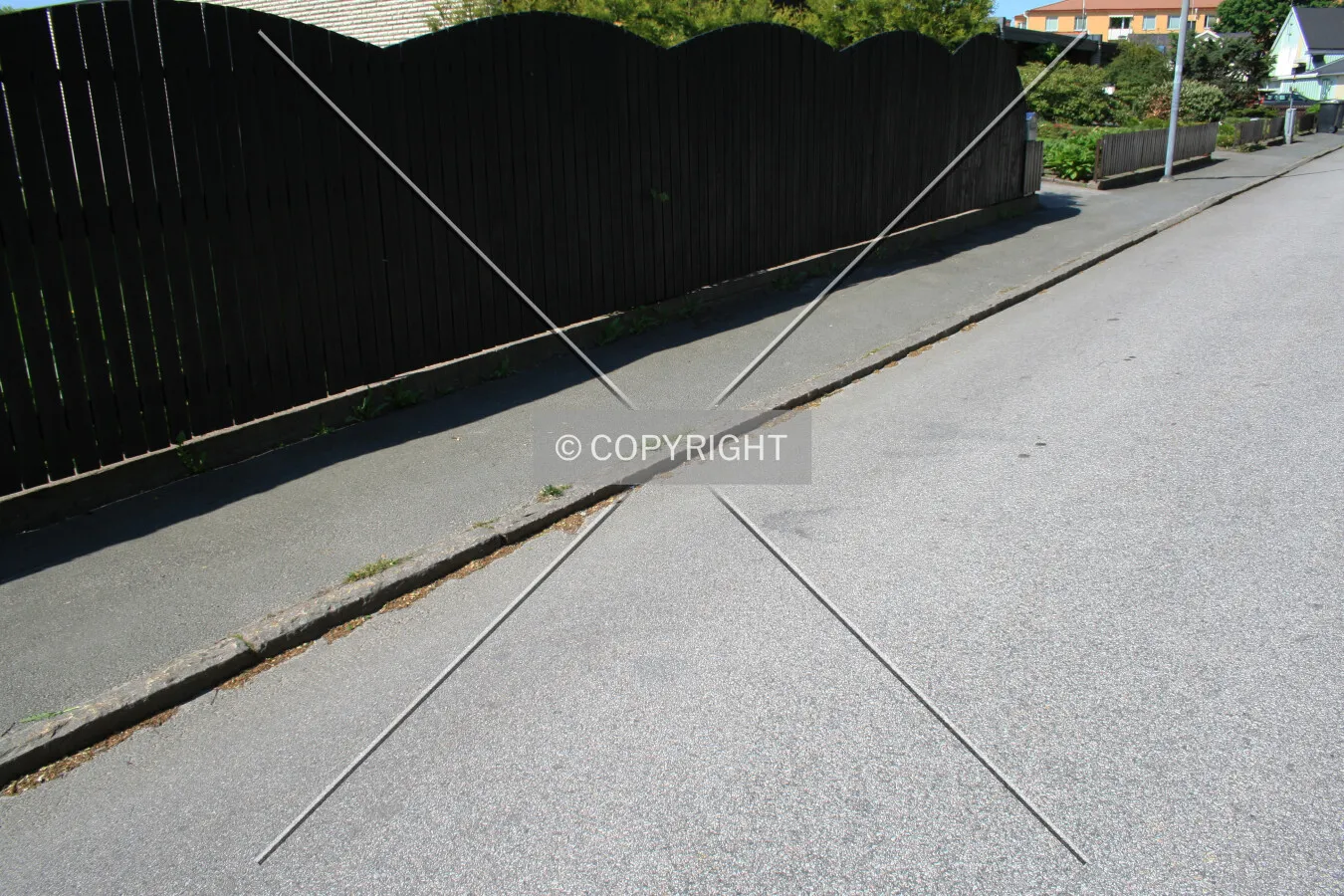 An asphalt sidewalk next to a street