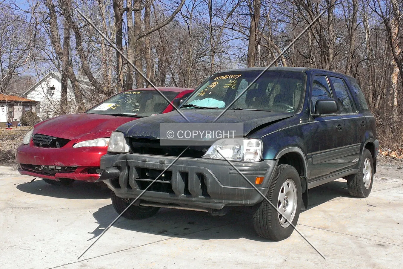 A wrecked Honda CR-V and Toyota Corolla at the Auto Auction
