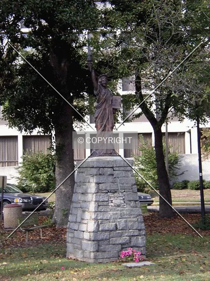 Miniature Statue of Liberty located in the front of the building