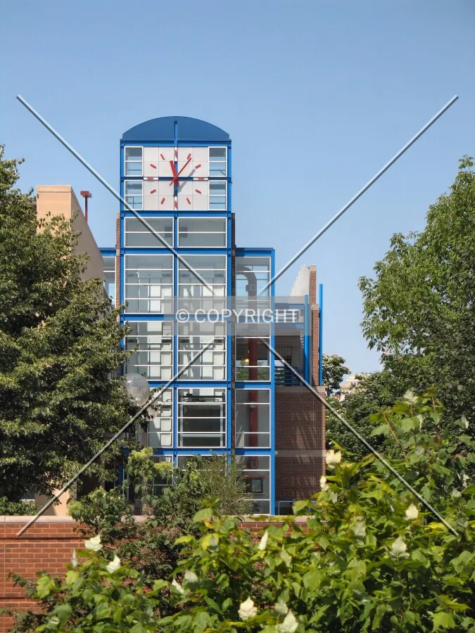 Clock atop elevator and stair tower on northeast corner
