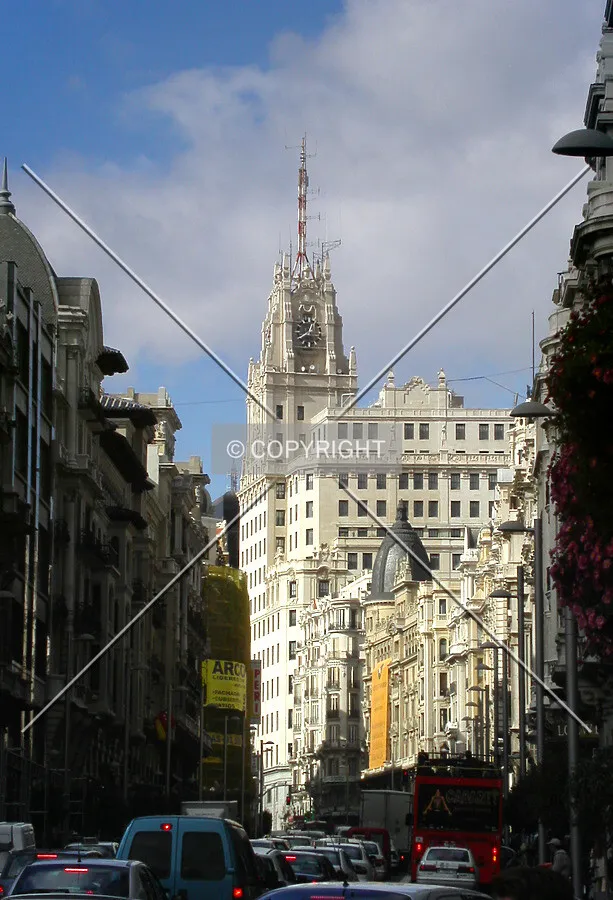 View of Gran Via with the building all lighted at the middle