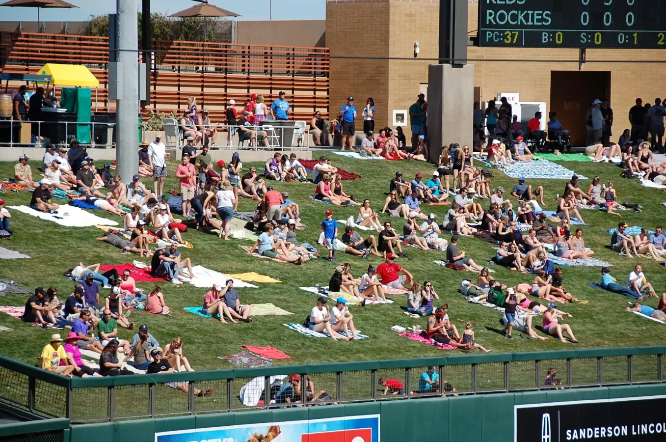 Spectators on the outfield lawn