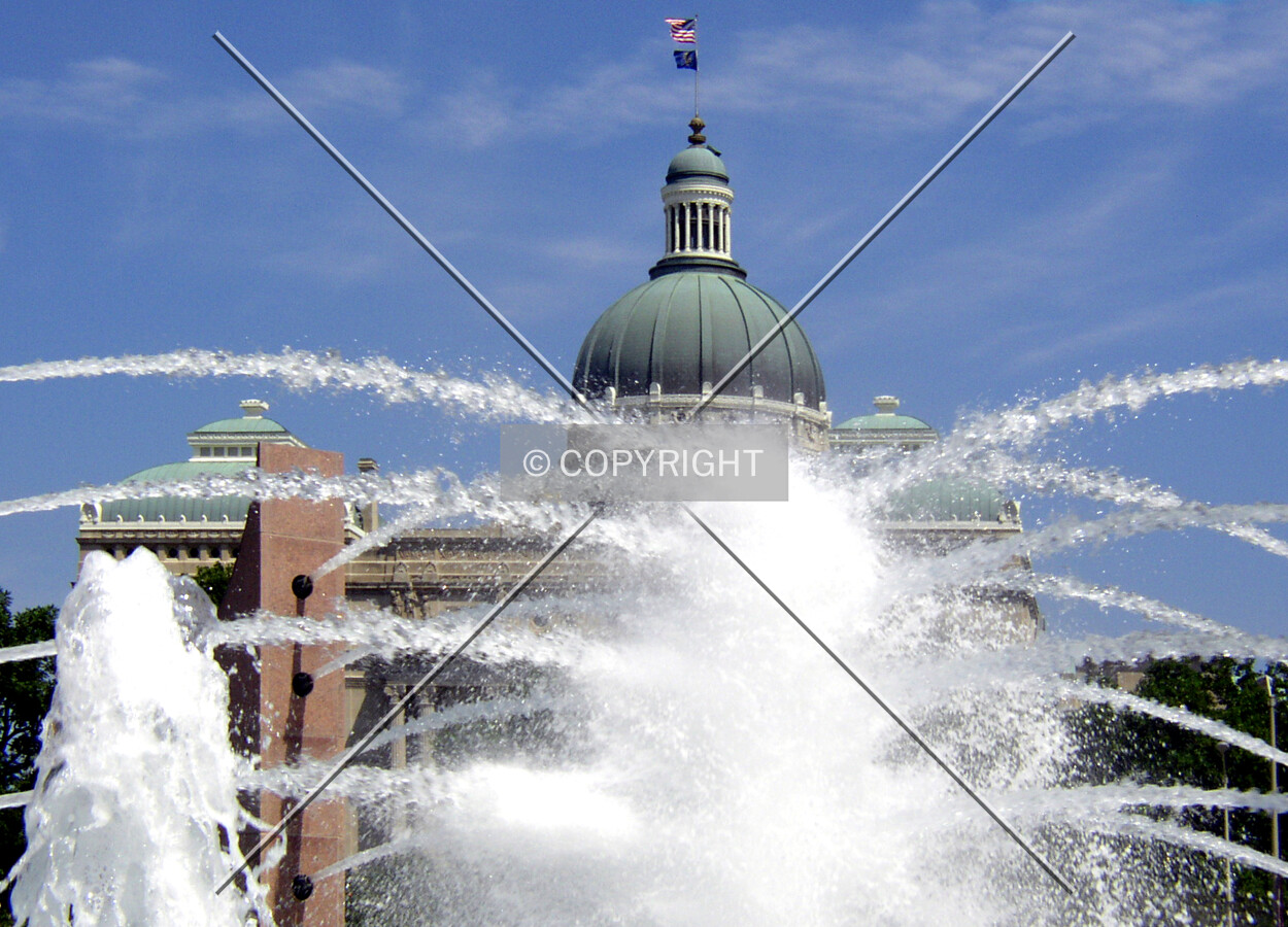 Top of the dome rising from behing the fountain in the Capitol Commons