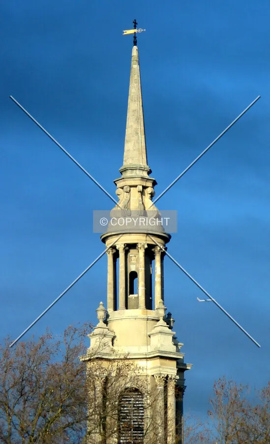 The slender spire outlined against a harsh sky