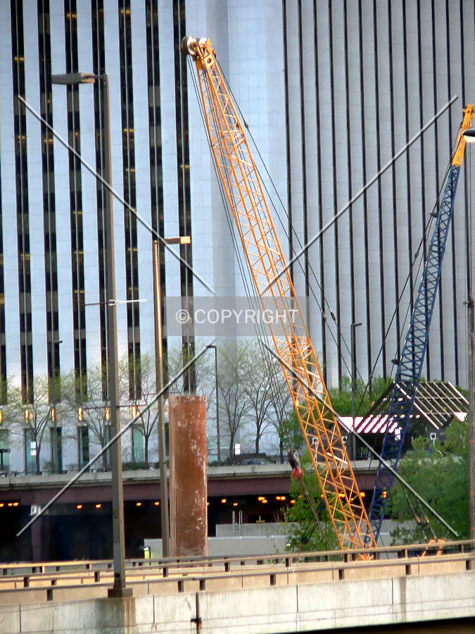 View to the southwest as a crane moves a caisson top