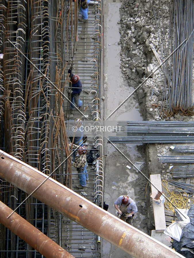 Workers installing rebar along the southern edge of the site