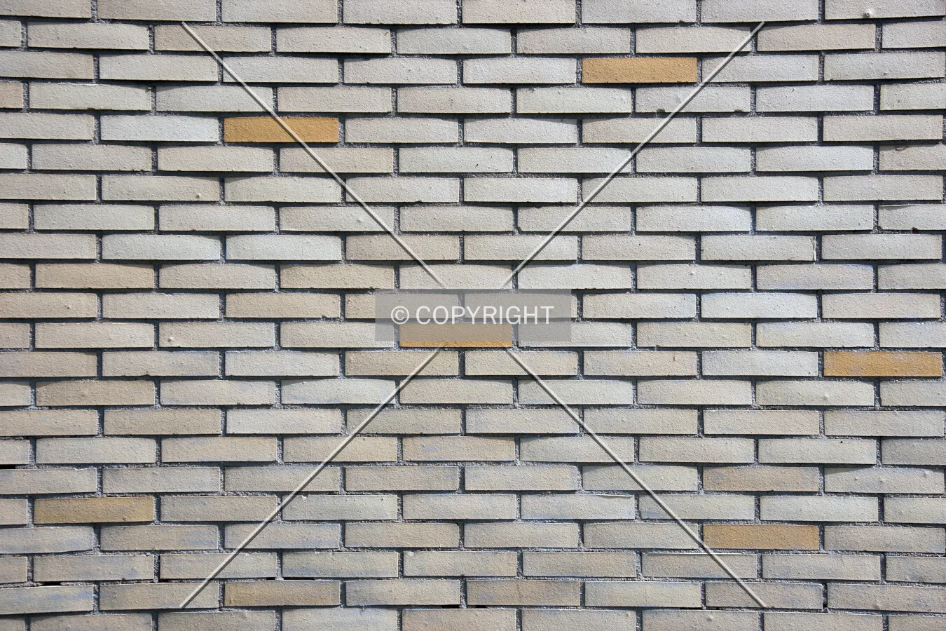 A lightbrown stone wall of bricks
