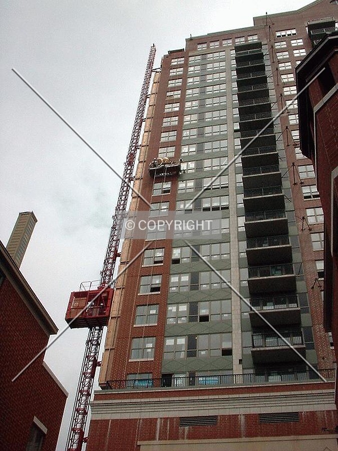 Construction elevator and workers washing windows, from 18th Street