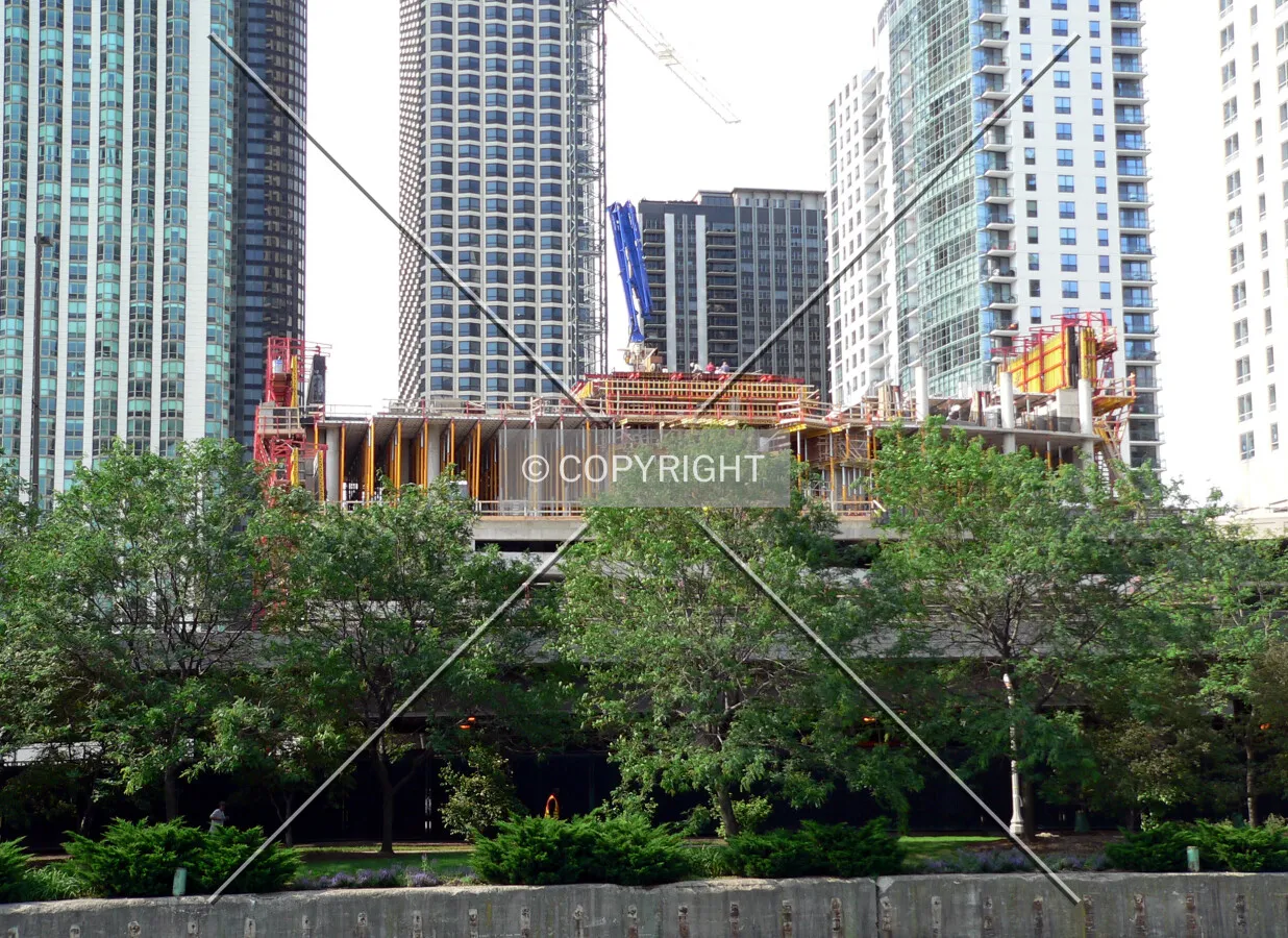 View of the structure rising above the trees from the Chicago River