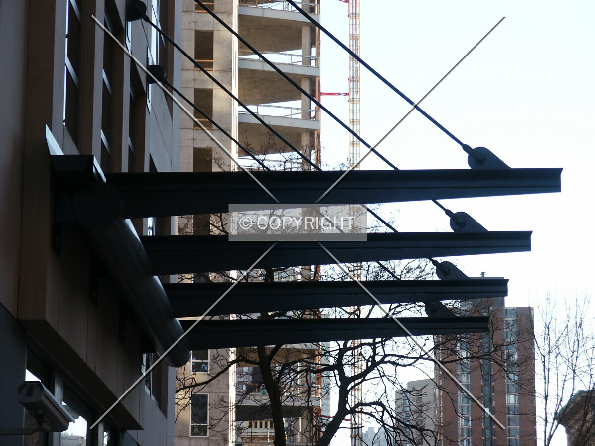 Entrance canopy with 30 West Oak under construction in the background
