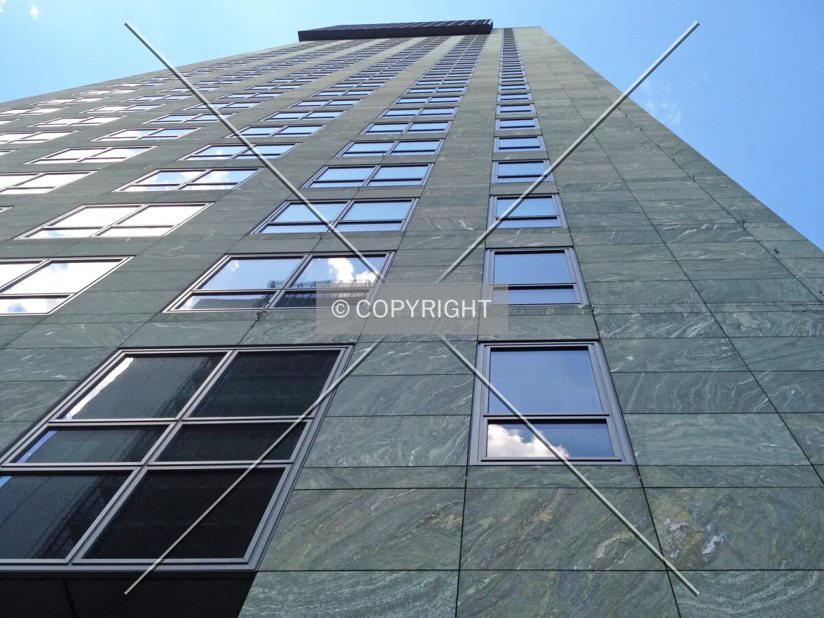 Looking along the facade to the top of the building
