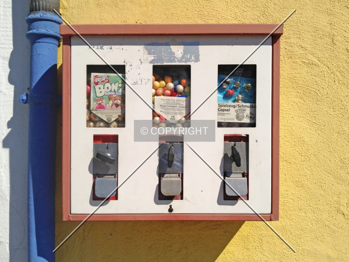 A bubble gum machine mounted on a wall
