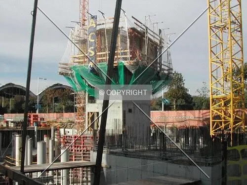 View of the main structural core rising over the construction fence