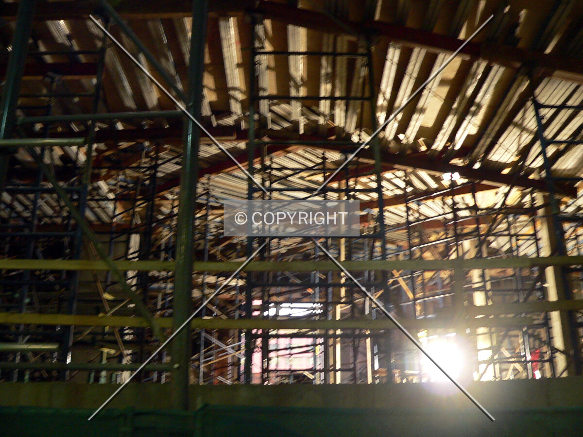 View into the structure from the alley with scaffolding visible