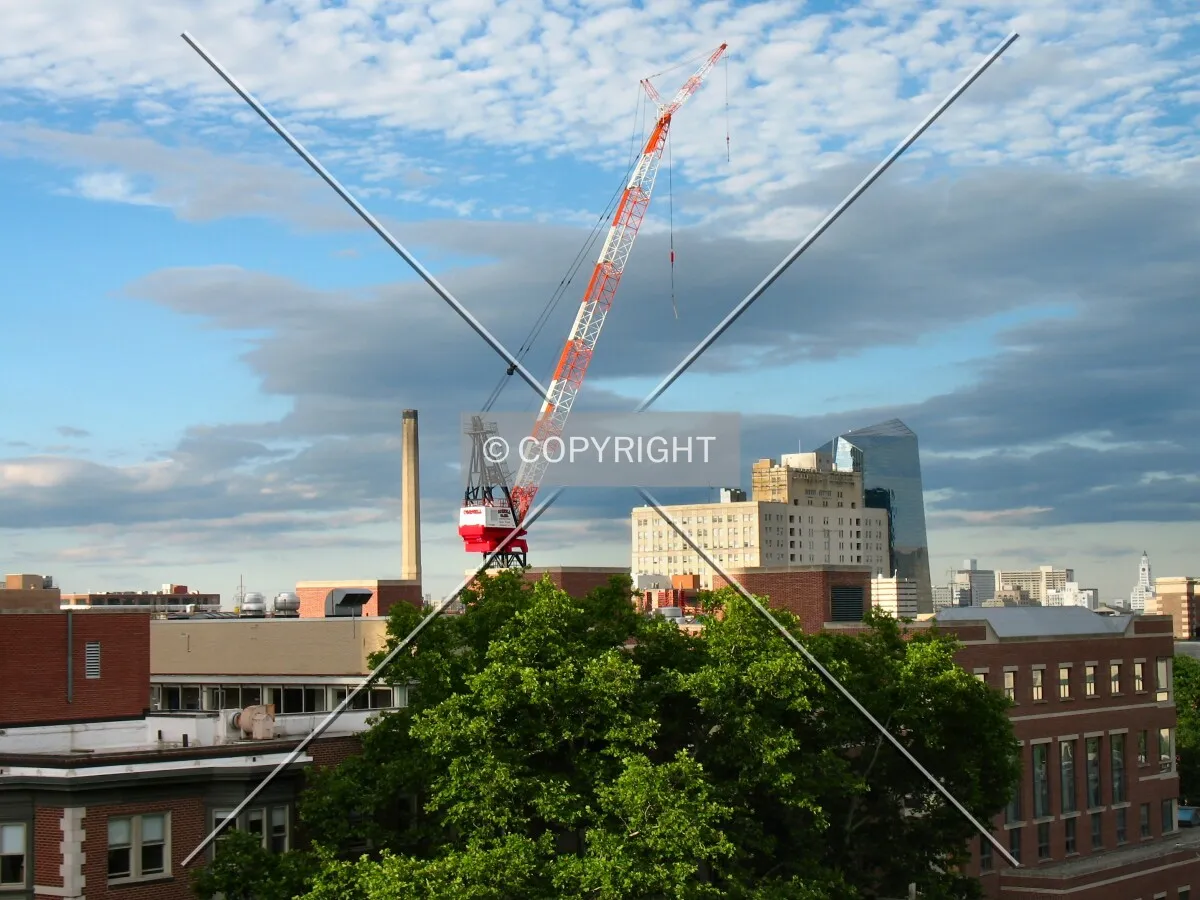 Elevated view of crane at dusk, Cira Centre in the distance