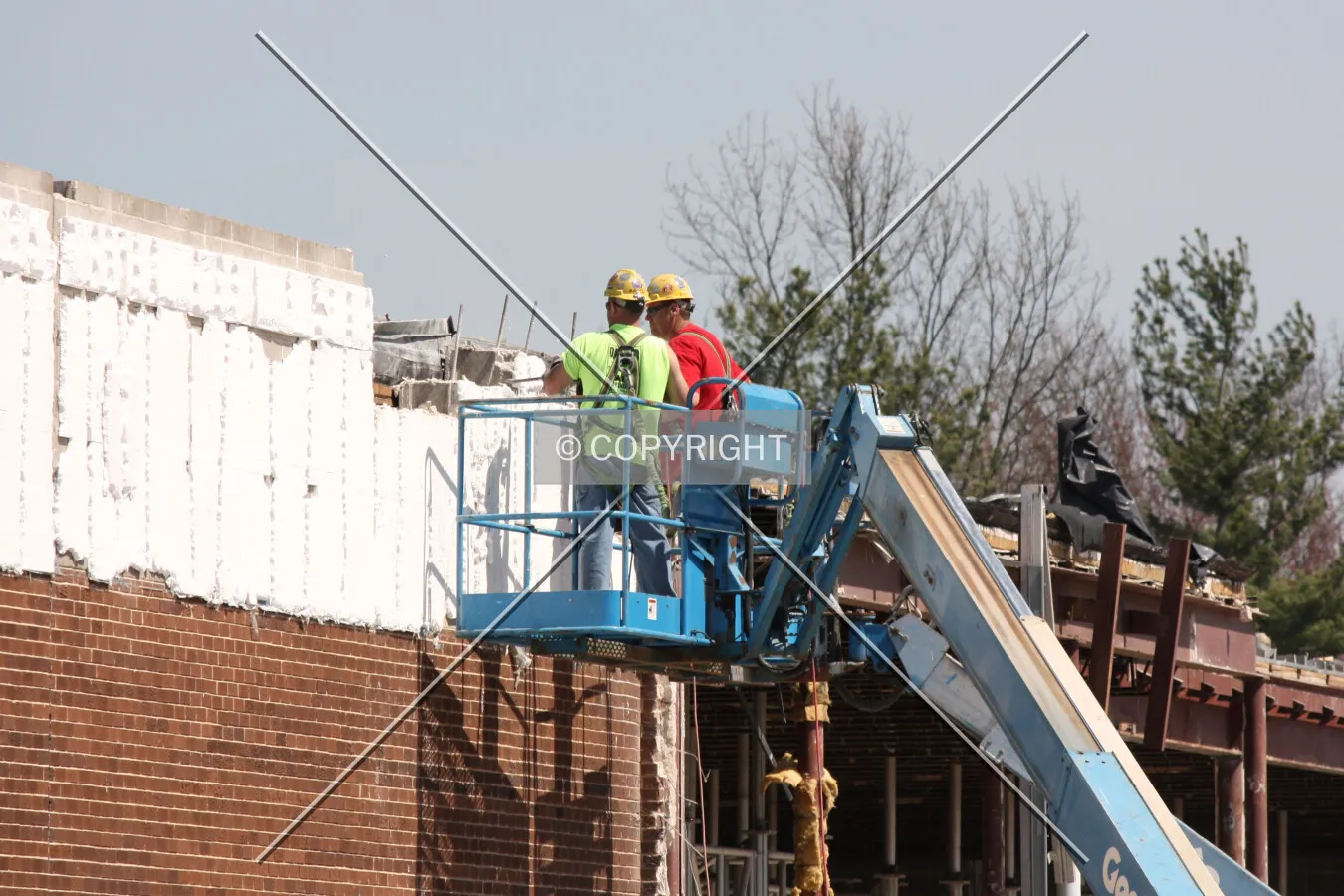 Workers removing the facade