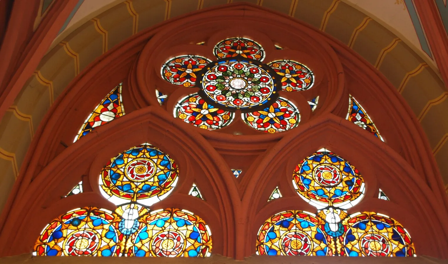 Red colored stained glass above the main entrance