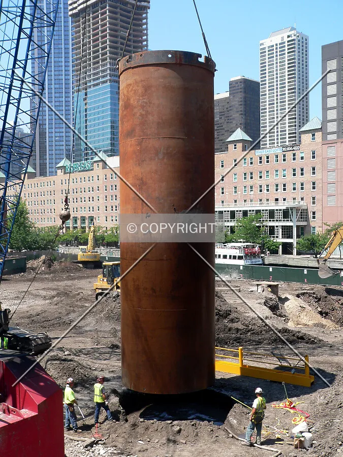 Placing a temporary caisson liner into a freshly drilled hole
