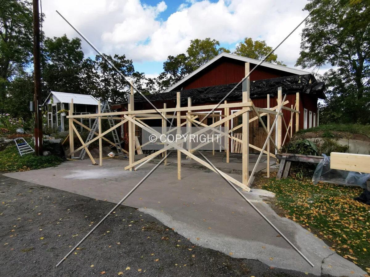 A shed is constructed on a plain surface