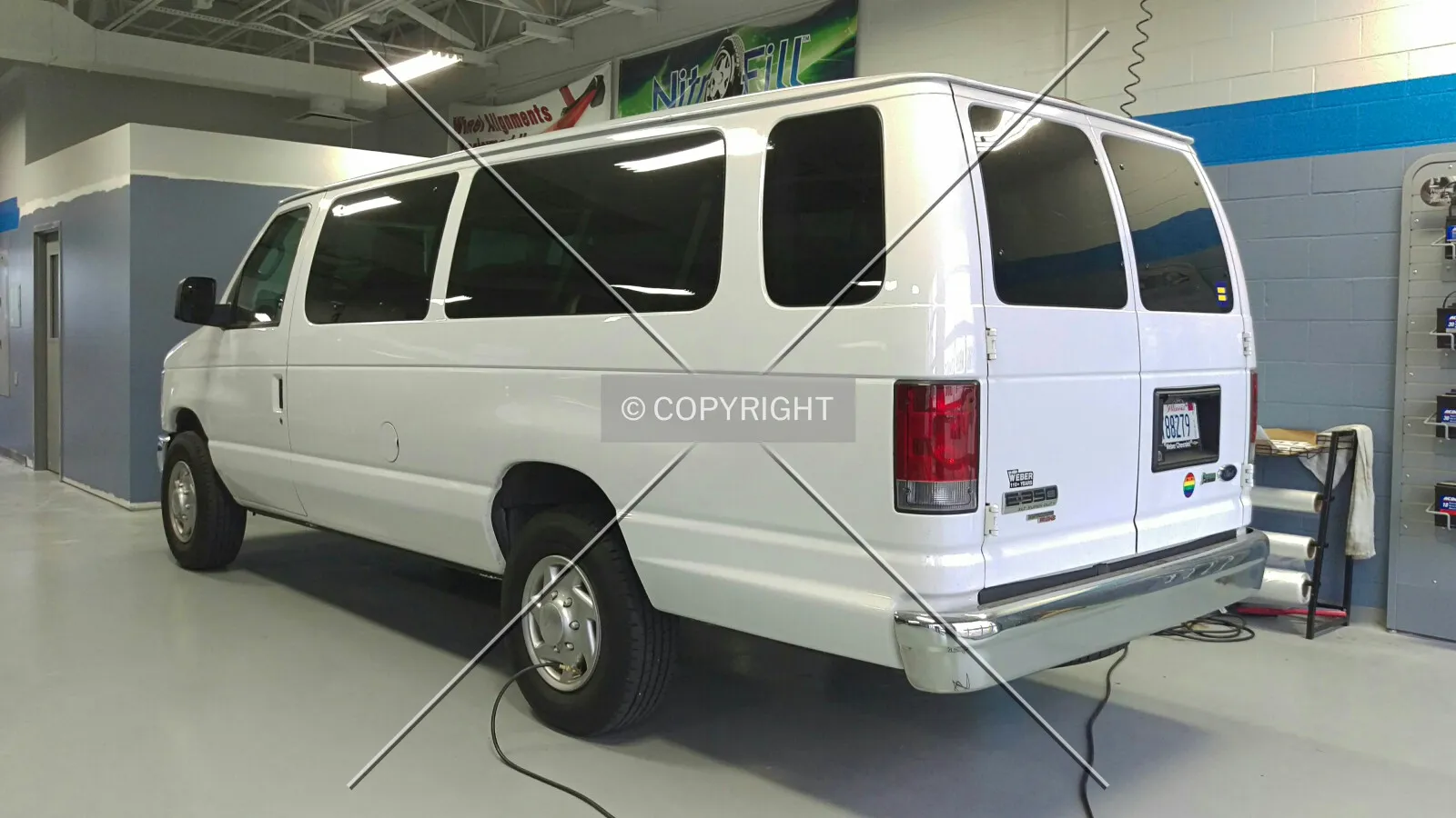 A 2010 Ford E-350 EXT XLT getting the tires filled with nitrogen in the service department; October 9, 2015